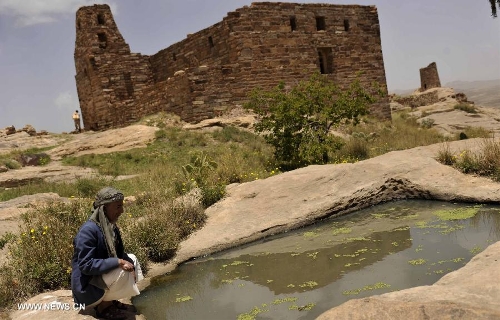 A Yemeni visitor looks at a cistern built to save rain water at the Thula Fort at the historical city of Thula, 45 km north of Sanaa, Yemen, on May 12, 2013. Thula Fort is one of 20 nominees for the 2013 Aga Khan Award for Architecture which is given every three years to projects that set new standards of excellence in architecture, planning practices, historic preservation and landscape architecture, in which Muslims have a significant presence. Thula boasts an impressive collection of stone buildings that date back to the 1st millennium BCE. The Thula fort was threatened by the disruption that might ensue from the construction of a road. However, the Yemeni government has undertaken a series of historic preservation projects to protect cultural assets, including rebuilding the walls of burial grounds, watch towers, paths and waterways, and repairing the cistern that remains in use to this day.(Xinhua/Mohammed Mohammed) 