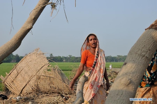 A woman cries over the death of her relatives and the loss of her belongings after a tornado in Brahmanbaria district, some 109 km east of the capital of Dhaka, Bangladesh, March 23, 2013. The death toll caused by a devastating tornado in eastern Bangladesh rose to 20 on Saturday, a local TV channel reported. (Xinhua/Shariful Islam)