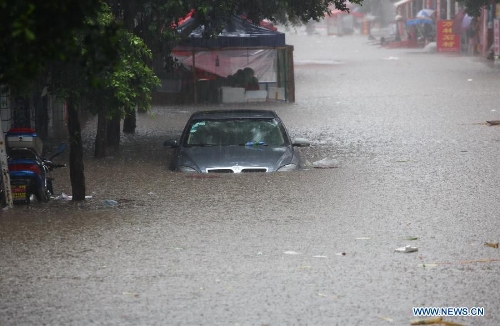 A sedan is stranded on a flooded road in Suining, southwest China's Sichuan Province, June 30, 2013. Rainstorm-triggered natural disasters have hit nine provincial-level regions since June 29, leaving at least 39 dead and another 13 missing, China's Ministry of Civil Affairs (MCA) said Monday. The National Meteorological Center (NMC) issued a blue alert for rainstorms on Monday, forecasting heavy rain to continue in parts of north and southwest China over the next three days. The NMC also warned of downpours, thunderstorms and hail in south China's coastal Guangdong province and the island province of Hainan, which are bracing for approaching tropical storm Rumbia. (Xinhua/Pu Feng)