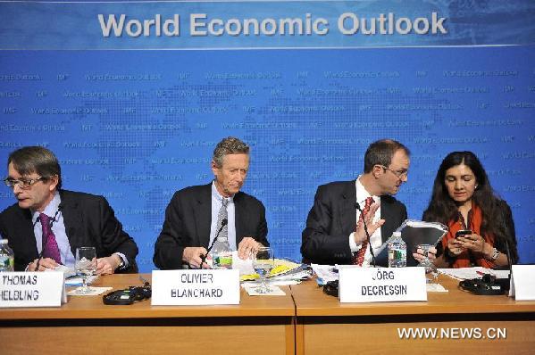 Economists of the International Monetary Fund (IMF) attend a news conference on the updated World Economic Outlook (WEO), a twice-yearly flagship report, in Washington D.C., capital of the United States, Jan. 23, 2013. The IMF said Wednesday that the world economy stands poised for a gradual upturn in 2013 with output rising by 3.5 percent.Photo: Xinhua