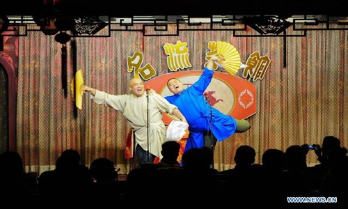 Cross talk actors perform on stage at a teahouse in Tianjin, north China, January 2, 2013.