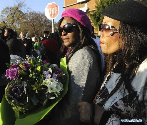 People gather outside the hospital where South Africa's anti-apartheid icon Nelson Mandela is treated in Pretoria, South Africa, to pray for Mandela, June 26, 2013. South Africa's President Zuma said on Wednesday that Mandela's condition 