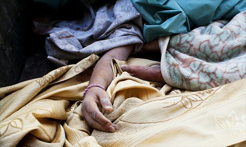 The hand of a victim is seen during the funeral of civilians killed in an air strike by the Syrian army in an undisclosed location in the northern province of Aleppo on Monday. It was the third air strike in as many days on Al-Bab, a town the rebel Free Syrian Army seized in late July along with large swathes of Aleppo, Syria's commercial capital. Photo: AFP 