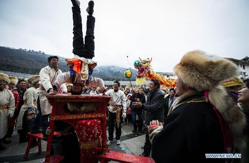 People of the Tibetan ethnic group perform at the Shangjiu Festival in Baoxing County, southwest China's Sichuan Province, Feb. 18, 2013. The residents of Tibetan ethnic group in Baoxing on Monday celebrated the annual Shangjiu Festival, which means the 9th day of Chinese Lunar New Year, to express the respect to the heaven. (Xinhua/Jiang Hongjing)  