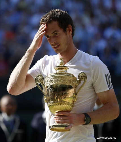 Andy Murray of Britain holds the trophy during the awarding ceremony for the men's singles event on day 13 of the Wimbledon Lawn Tennis Championships at the All England Lawn Tennis and Croquet Club in London, Britain, July 7, 2013. Andy Murray on Sunday won his first Wimbledon title and ended Britain's 77-year waiting for a men's champion with a 6-4 7-5 6-4 victory over world number one Novak Djokovic. (Xinhua/Wang Lili)