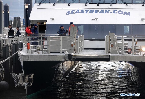  Rescue teams work on a ferry boat which crashed into Pier 11 in lower Manhattan, New York, the United States, on Jan. 9, 2013. A high-speed ferry loaded with hundreds of commuters from New Jersey crashed into a dock near Wall Street on Wednesday during the morning rush hour, injuring 57 people. (Xinhua/Shen Hong) 