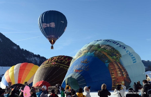 Balloons take off at the 35th International Ballon Festival in Chateau-d'Oex, Switzerland, Jan. 26, 2013. The 9-day ballon festival kicked off here on Saturday with the participation of over 80 balloons from 15 countries and regions. (Xinhua/Wang Siwei) 