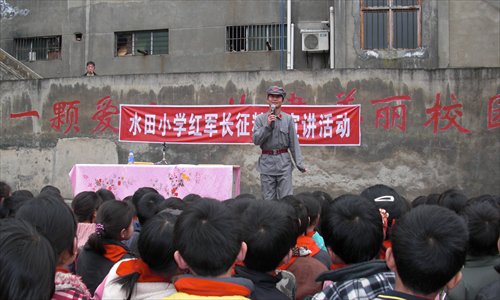 Chinese adventurer Yang Bo speaks to students at a primary school in Yunnan Province during his Long March trek