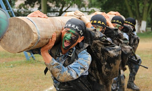 An armored regiment of the Marine Corps under the Navy of the Chinese People's Liberation Army (PLA) keeps the actual-combat requirements in mind and tempers its troops all-roundly. By adding the obstacles and setting up lifelike battle atmosphere in training, the regiment has cultivated the first-rate capability of the officers and men. (China Military Online/Zeng Liang)