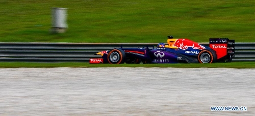 Red Bull driver Sebastian Vettel of Germany steers his car during the Malaysian F1 Grand Prix at Sepang International Circuit outside Kuala Lumpur, Malaysia, March 24, 2013. (Xinhua/Chong Voon Chung) 