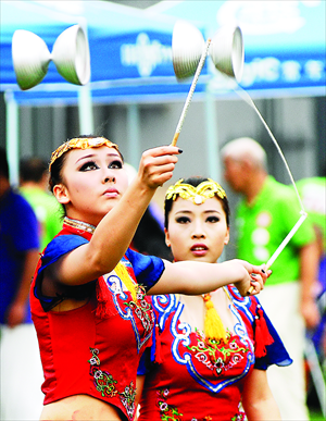 A woman performs diabolo tricks at a diabolo cultural festival held at Beijing Huimin High School on Thursday. The Diabolo was listed as one of China's intangible cultural heritages in 2006. Foreign diabolo fans from countries including the US and Russia also took part in the festival. Photo: CFP