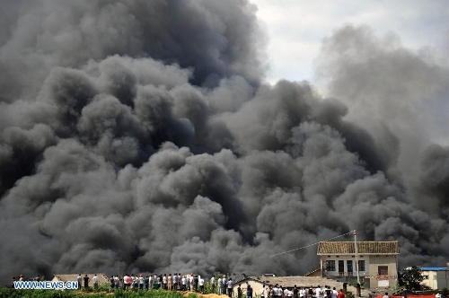 Heavy smoke billows from a warehouse near the Changsha South Railway Station in Changsha, capital of central China's Hunan Province, July 2, 2013. A fire engulfed the warehouse Sunday without injuring anyone. Local fire department took more than two hours to douse the fire. (Xinhua/Li Ga) 