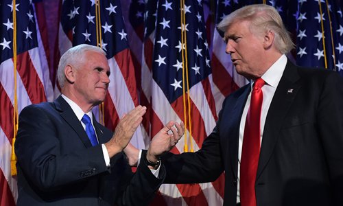 US Republican presidential elect Donald Trump (right) reaches to his vice president elect Mike Pence during election night at the New York Hilton Midtown in New York on Wednesday. Photo: AFP