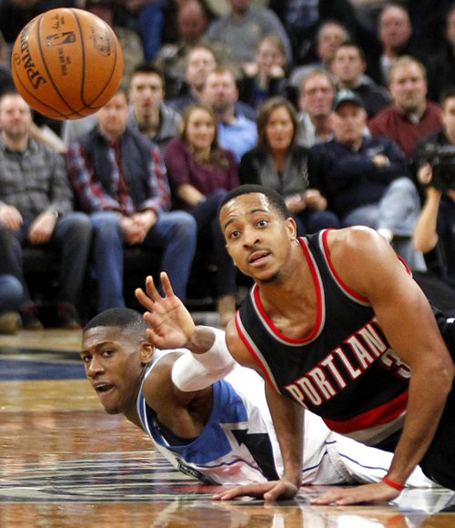 Portland Trail Blazers guard C.J. McCollum (right) and Minnesota Timberwolves guard Chris Dunn dive for the ball in Minneapolis on Sunday. Photo: IC