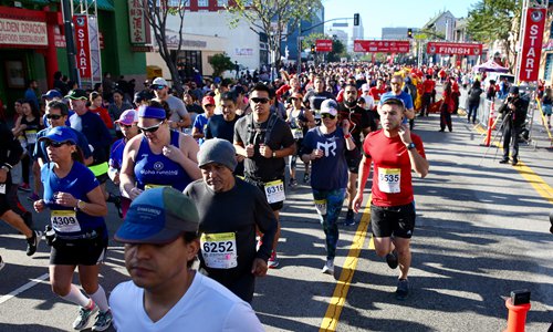 Runners stretch their legs during the 39th Annual Los Angeles Chinatown Firecrackers Run/Walk on February 12. More than 7,000 participants took part in the event.Photo: Yu Yan