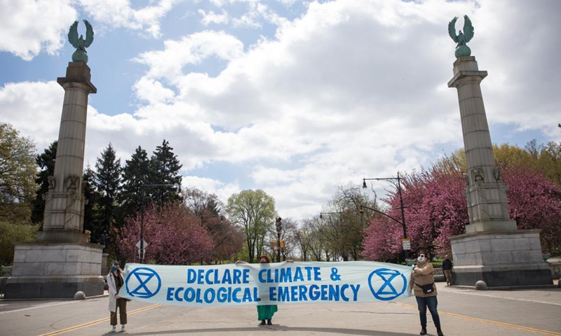 Activists hold a sign on Earth Day in front of Prospect Park in the Brooklyn borough of New York, the United States, on April 22, 2021.Photo:Xinhua