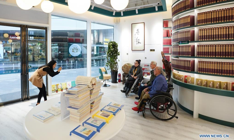 Three readers with disabilities pose for a group photo at Shanyuan Book Chamber in Beijing, capital of China, April 14, 2021. Photo:Xinhua