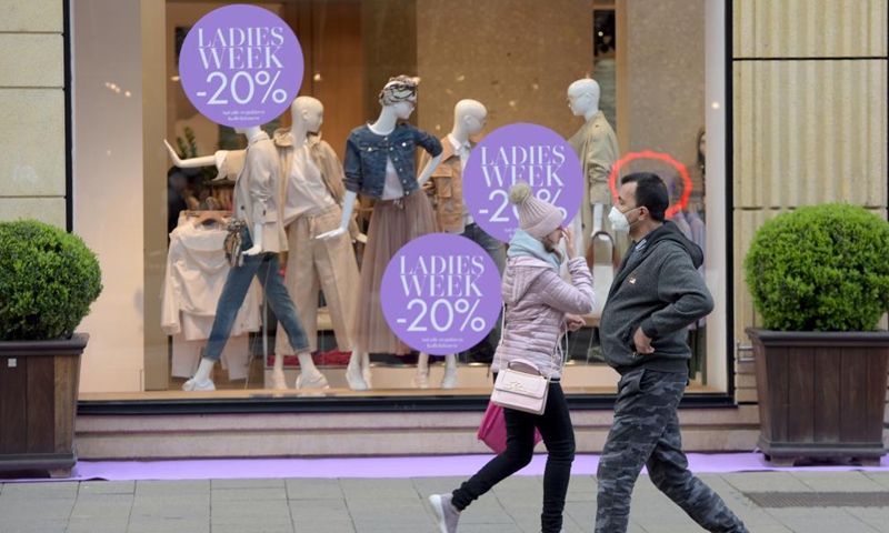 People pass by a shopwindow in Vienna, Austria, May 3, 2021. Retailers and service providers were allowed to reopen under certain conditions in Vienna on Monday. (Xinhua/Guo Chen)