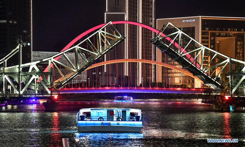 A boat drives past the opened Jiefang Bridge in Tianjin, north China, May 1, 2021. (Xinhua/Sun Fanyue)