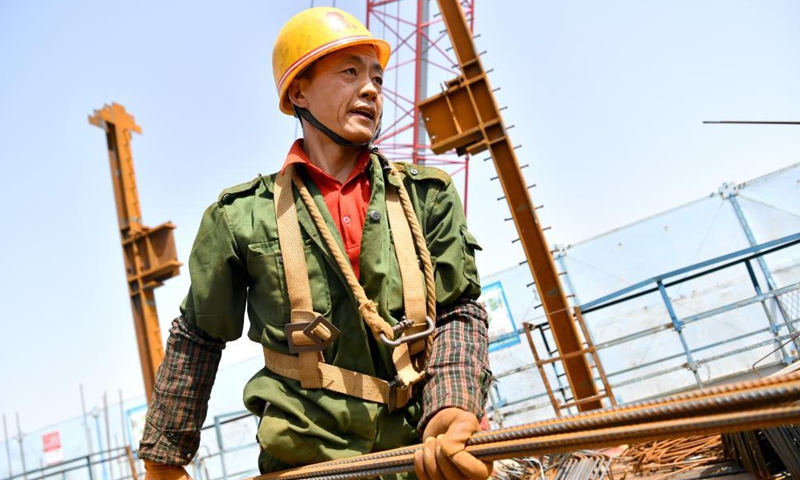 A worker from China Railway Seventh Group Co., Ltd. works at the construction site of a project in Weiyang District of Xi'an City, capital of northwest China's Shaanxi Province, May 1, 2021. People from various sectors stick to their posts during the Labor Day holiday. Photo: Xinhua