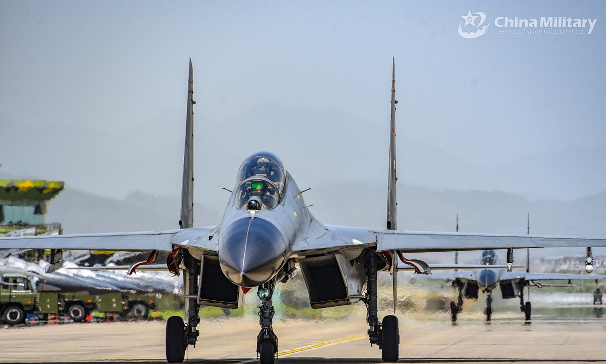 Fighter jets attached to a naval aviation brigade under the PLA Eastern Theater Command get ready to take off for a flight training exercise on April 17, 2021. (eng.chinamil.com.cn/Photo by Fu Gan)