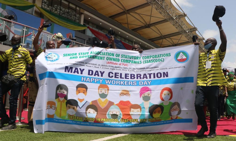 People parade at an event celebrating the International Workers' Day in Lagos, Nigeria, on May 1, 2021. (Photo by Emma Houston/Xinhua)