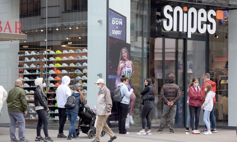 People wait to enter a store in Vienna, Austria, May 3, 2021. Retailers and service providers were allowed to reopen under certain conditions in Vienna on Monday. (Xinhua/Guo Chen)