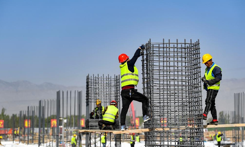 Workers are busy at the construction site of a smart factory in the economic and technological development zone in Yinchuan City, northwest China's Ningxia Hui Autonomous Region, May 1, 2021. People from various sectors stick to their posts during the Labor Day holiday. Photo: Xinhua