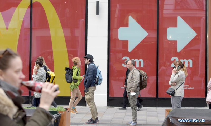 People wait to enter a store in Vienna, Austria, May 3, 2021. Retailers and service providers were allowed to reopen under certain conditions in Vienna on Monday. (Xinhua/Guo Chen)