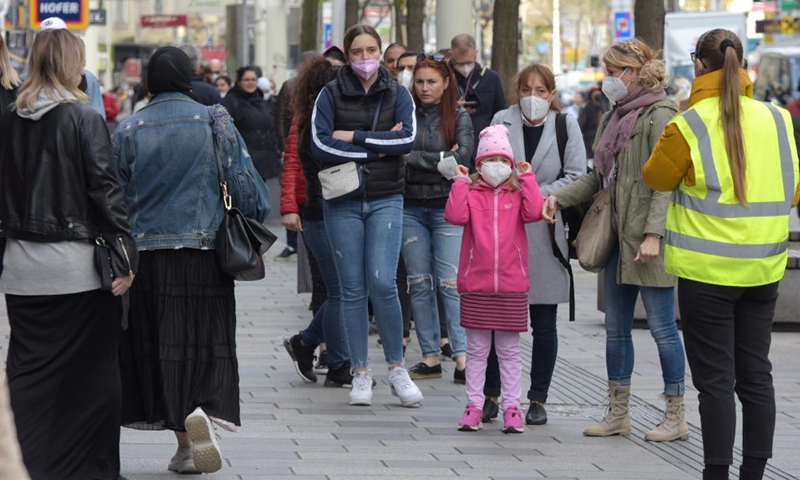 People wait to enter a store in Vienna, Austria, May 3, 2021. Retailers and service providers were allowed to reopen under certain conditions in Vienna on Monday. (Xinhua/Guo Chen)