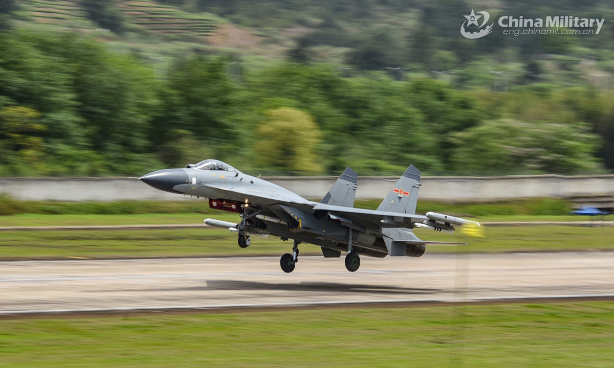 Fighter jet attached to a naval aviation brigade under the PLA Eastern Theater Command takes off from the runway during a flight training exercise on April 17, 2021. (eng.chinamil.com.cn/Photo by Fu Gan)