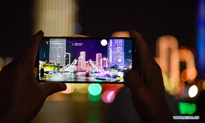 A citizen takes photos of the opened Jiefang Bridge in Tianjin, north China, May 1, 2021. (Xinhua/Sun Fanyue)