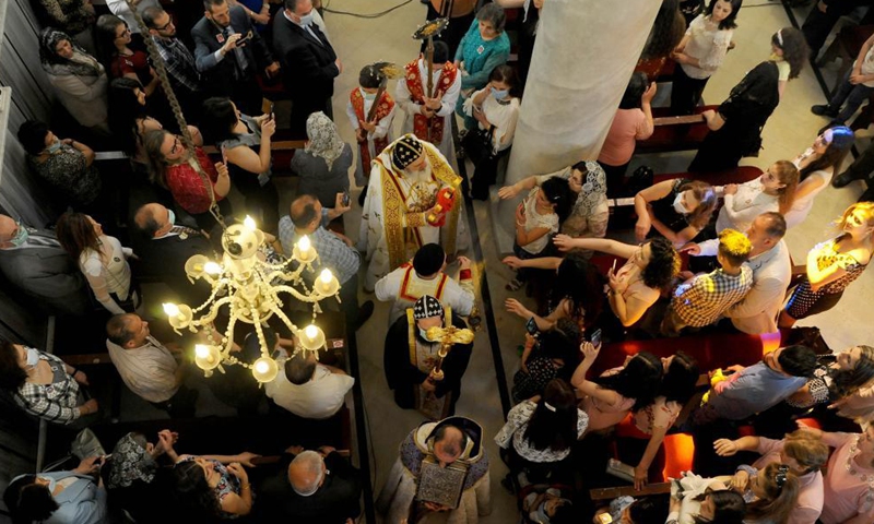 People pray on the occasion of Easter at a church in Damascus, Syria, on May 2, 2021. (Photo by Ammar Safarjalani/Xinhua)