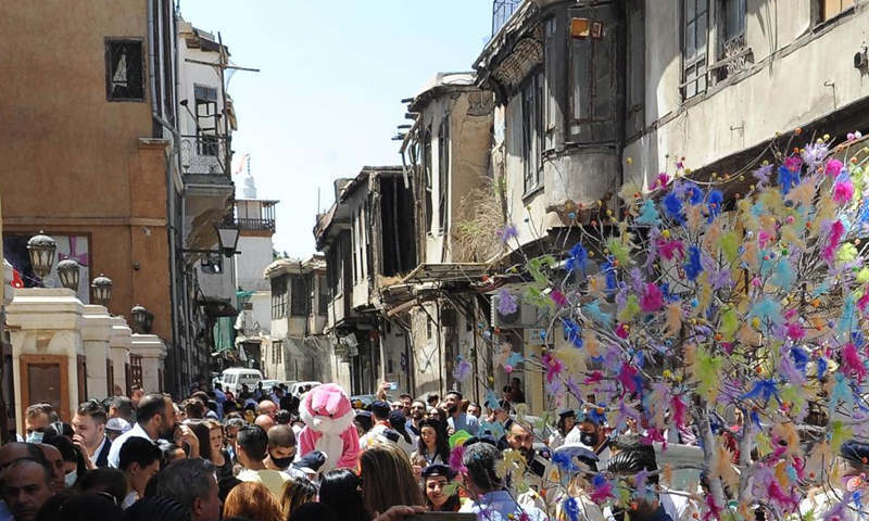 People gather during the Easter celebrations east of Damascus, Syria, on May 2, 2021. (Photo by Ammar Safarjalani/Xinhua)