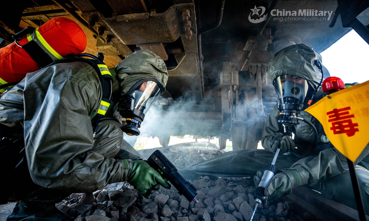 Armed policemen in Mission-Oriented Protective Posture (MOPP) gears follow poisonous gas decontamination procedures in a simulated railway carriage during a chemical defense training exercise. A chemical defense element under the Chinese People’s Armed Police (PAP) Force Tianjin Contingent conducted an emergency training exercise on April 28, 2021.Photo:China Military