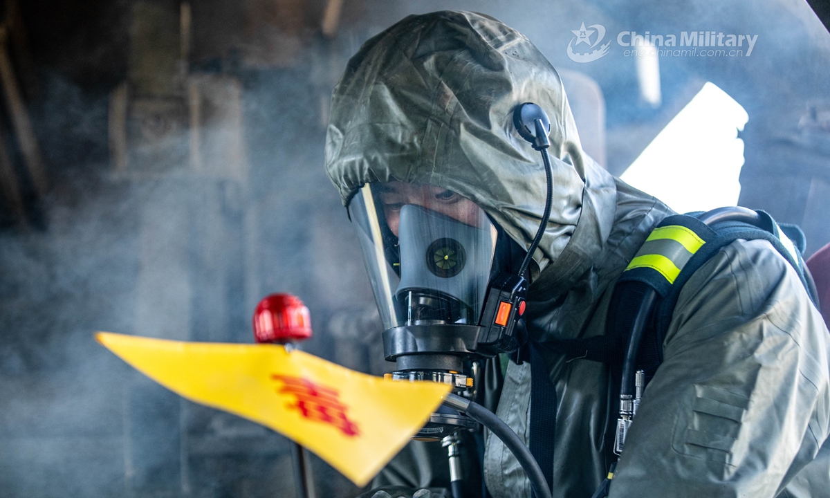 Armed policemen in Mission-Oriented Protective Posture (MOPP) gears follow poisonous gas decontamination procedures in a simulated railway carriage during a chemical defense training exercise. A chemical defense element under the Chinese People’s Armed Police (PAP) Force Tianjin Contingent conducted an emergency training exercise on April 28, 2021.Photo:China Military