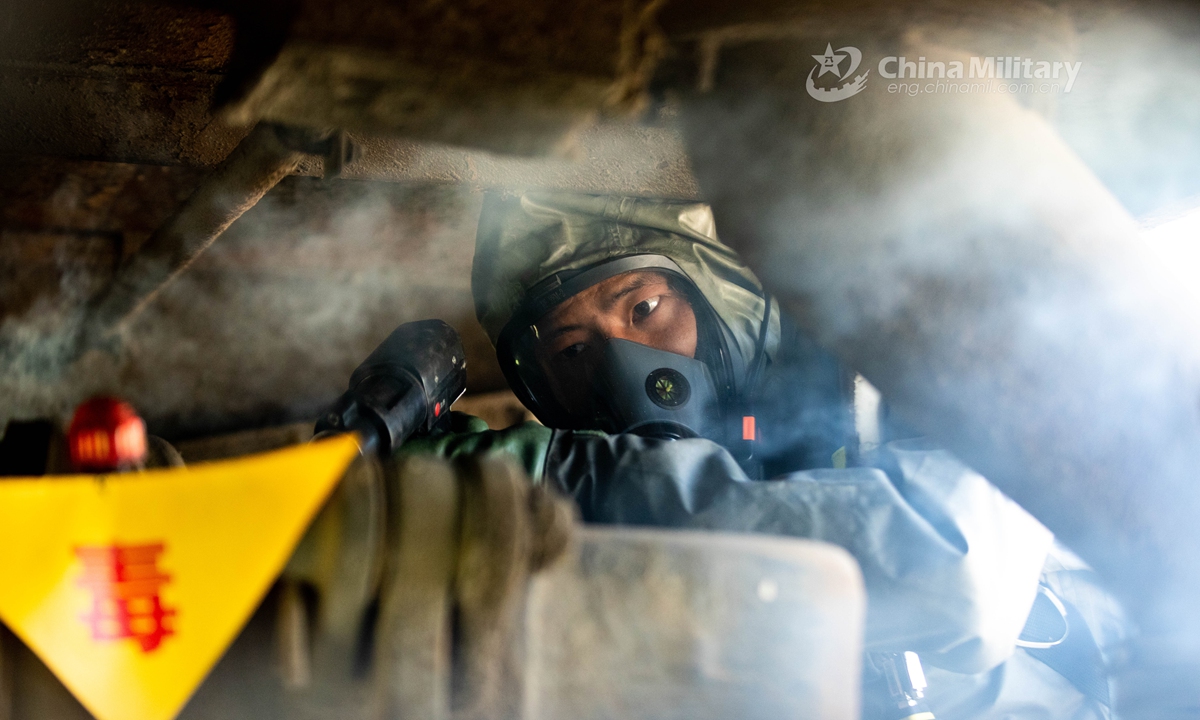 Armed policemen in Mission-Oriented Protective Posture (MOPP) gears follow poisonous gas decontamination procedures in a simulated railway carriage during a chemical defense training exercise. A chemical defense element under the Chinese People’s Armed Police (PAP) Force Tianjin Contingent conducted an emergency training exercise on April 28, 2021.Photo:China Military