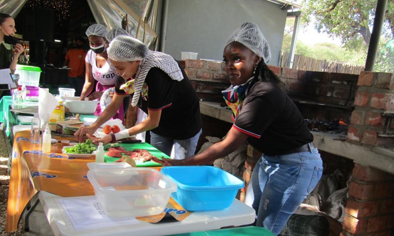 Participants prepare their dishes at the official launch of a nationwide annual Kapana cook-off in Windhoek, Namibia, on May 7, 2021. Namibia hosted the event on Friday in search of Namibia's best Kapana cooks in the country. Kapana is a way of preparing raw meat, typically beef by grilling it on an open fire.Photo:Xinhua