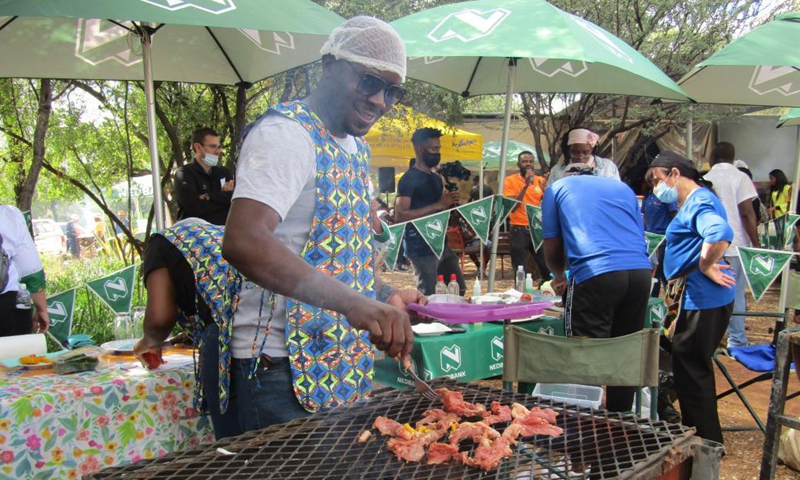 A participant grills beef on an open fire at the official launch of a nationwide annual Kapana cook-off in Windhoek, Namibia, on May 7, 2021. Namibia hosted the event on Friday in search of Namibia's best Kapana cooks in the country. Kapana is a way of preparing raw meat, typically beef by grilling it on an open fire. Photo:Xinhua