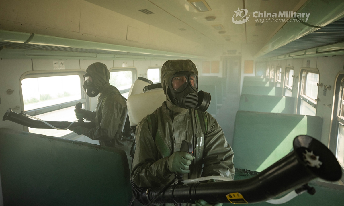 Armed policemen in Mission-Oriented Protective Posture (MOPP) gears follow poisonous gas decontamination procedures in a simulated railway carriage during a chemical defense training exercise. A chemical defense element under the Chinese People’s Armed Police (PAP) Force Tianjin Contingent conducted an emergency training exercise on April 28, 2021.Photo:China Military