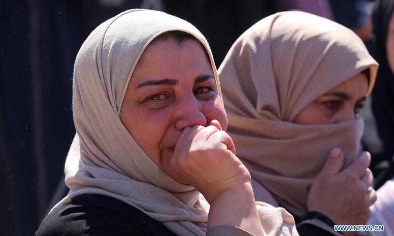 A relative of Palestinian Malek Hamdan, 22, who was killed during clashes with Israeli soldiers, mourns during his funeral in Salem village, east of the West Bank city of Nablus, May 15, 2021.(Photo: Xinhua)