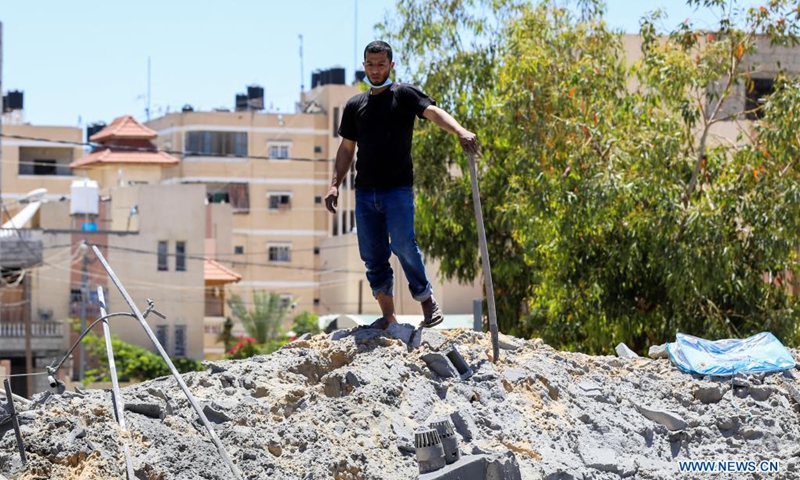 A Palestinian stands on the rubble of a house destroyed by Israeli airstrikes, in Khan Younis refugee camp in the southern Gaza Strip, May 15, 2021.(Photo: Xinhua)