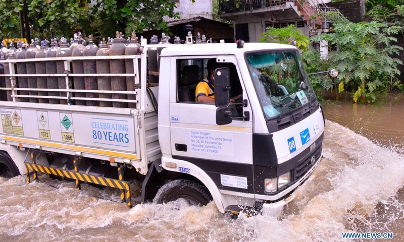 A truck carrying oxygen cylinders moves along a flooded road in Gampaha, Sri Lanka, May 15, 2021. At least four people had died and over 42,000 others had been affected by days of strong winds and heavy rains which lashed the country due to the formation of a super cyclone in the Bay of Bengal, Sri Lanka's Disaster Management Center (DMC) said in its latest weather report Saturday.(Photo: Xinhua)