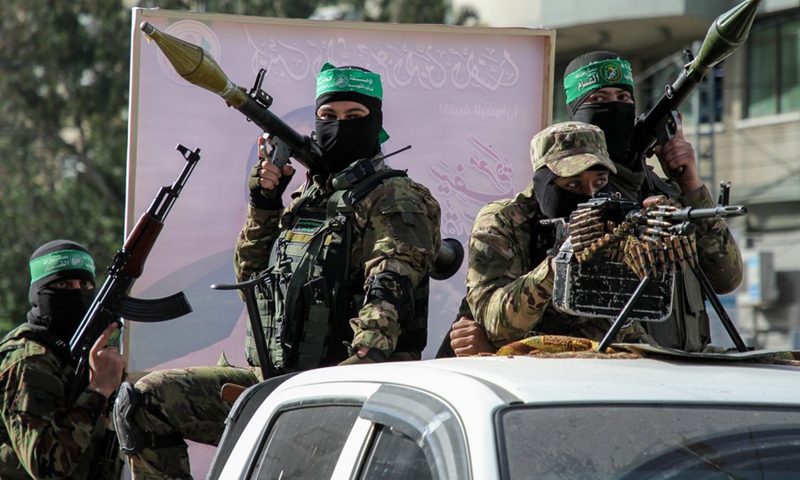 Palestinian militants of al-Qassam Brigades, the armed wing of the Hamas movement, hold a military parade in Gaza city after reaching ceasefire with Israel after a 11-day fighting.(Photo: Xinhua)