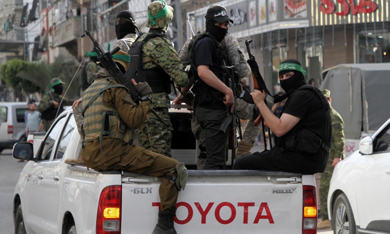 Palestinian militants of al-Qassam Brigades, the Hamas' armed wing, sit on a pickup during a military parade in Gaza city, May 22, 2021.(Photo: Xinhua)