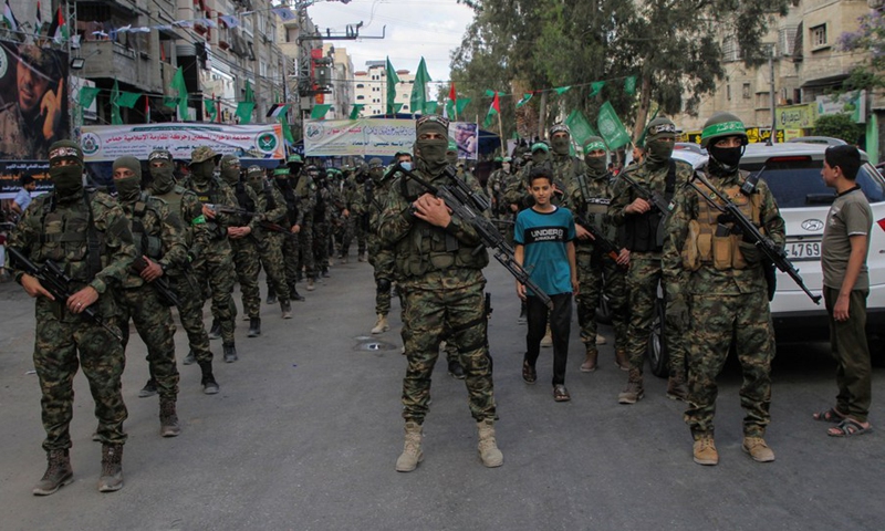 Palestinian militants of al-Qassam Brigades, the Hamas' armed wing, stand in formation during a military parade in Gaza city, May 22, 2021.(Photo: Xinhua)