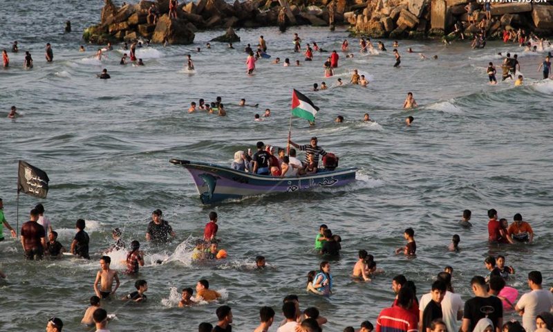 Palestinians enjoy themselves on a beach by the Mediterranean Sea off Gaza coast in Gaza City, on May 28, 2021.Photo:Xinhua