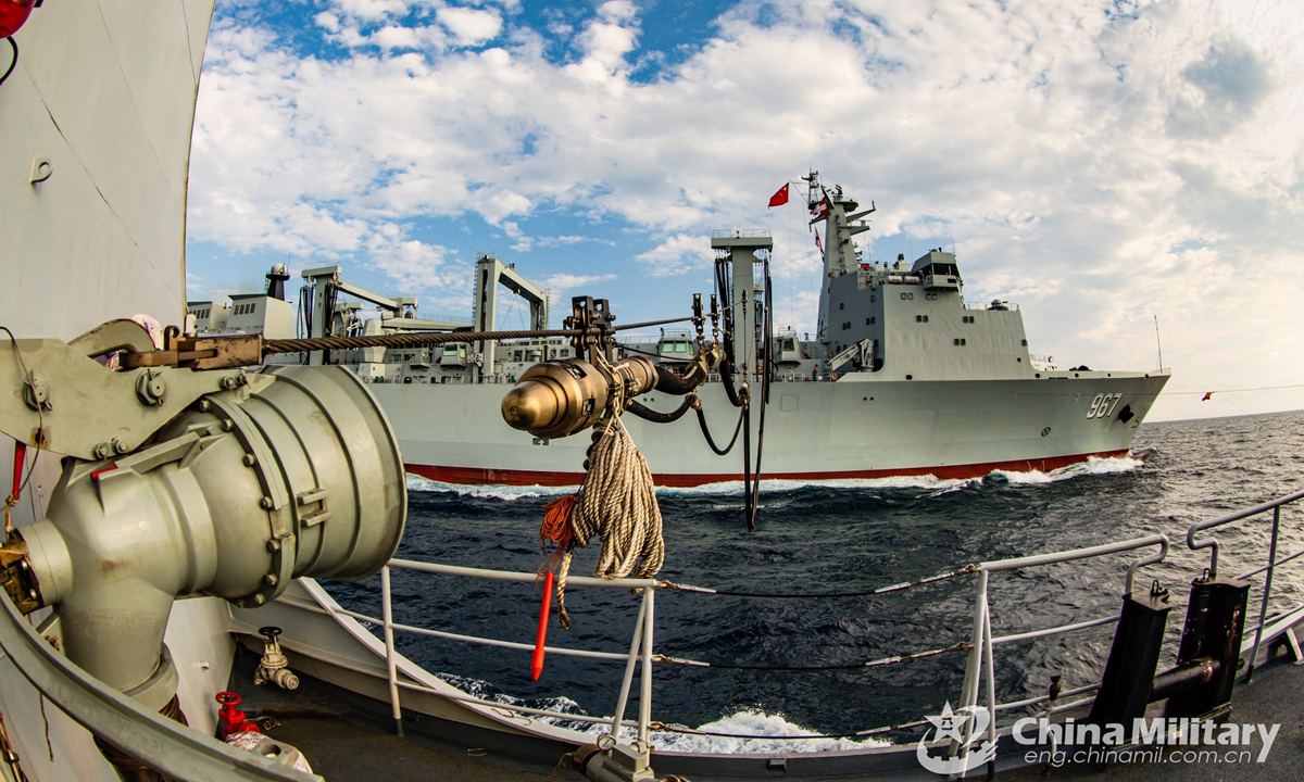 A warship attached to a destroyer flotilla with the navy under the PLA Southern Theater Command receives the refueling probe from the comprehensive supply ship Chaganhu (Hull 967) during a four-day-long realistic-combat training exercise in waters of the South China Sea.Photo:China Military