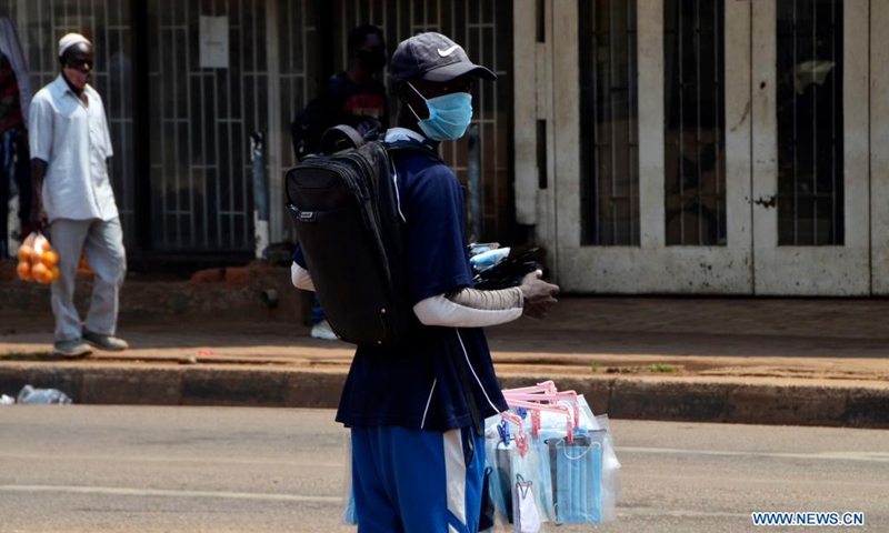 A vendor sells face masks on a street in Kampala, Uganda, on July 4, 2021. Uganda has introduced new penalties for offenders of the country's COVID-19 prevention procedures. A statutory instrument dubbed Public Health (Control of COVID-19) rules 2021, signed by Health Minister Ruth Aceng, said that if one is found guilty of not wearing a facial mask while in public places, he or she will face a jail term of two months.(Photo: Xinhua)