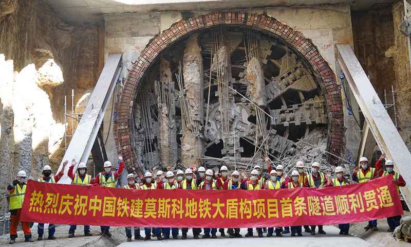 Chinese and Russian construction workers celebrate the completion of the Moscow subway tunnel section on Monday. Photo: Courtesy of CRCC